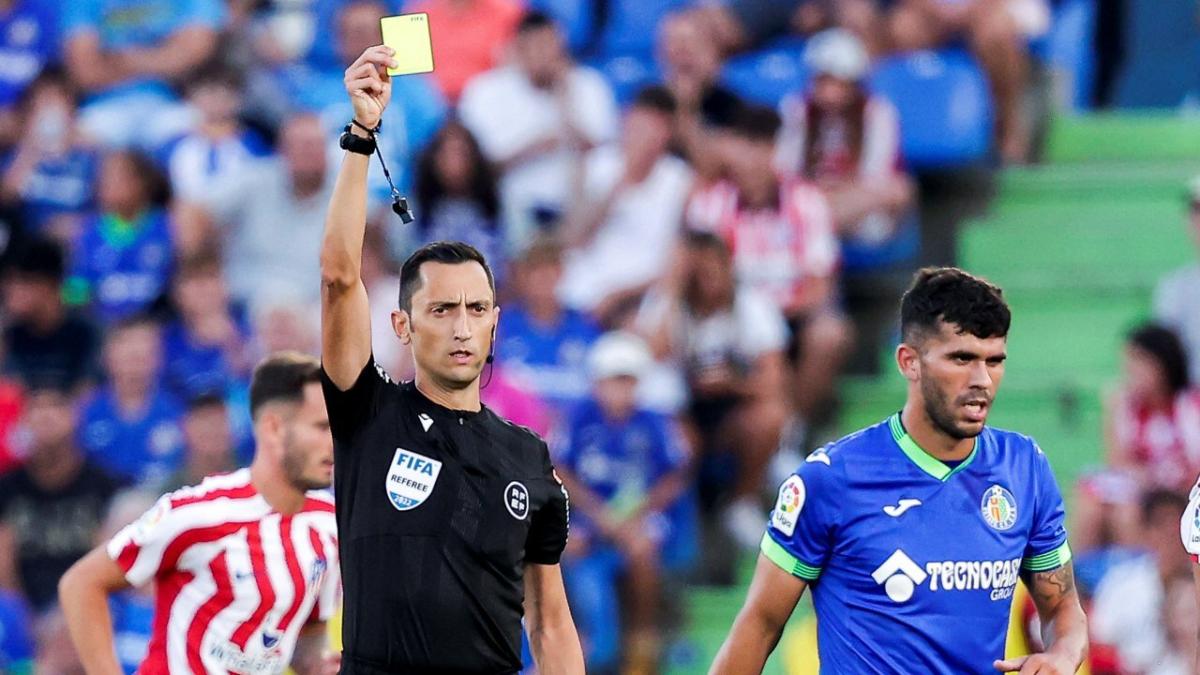 Getafe's Carles Alena receives a card